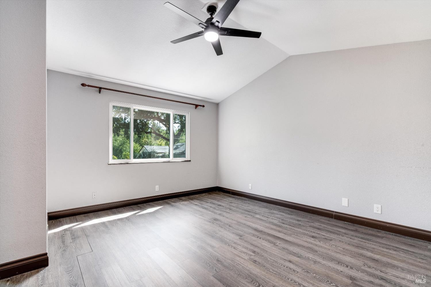 187 Wikiup Meadows Drive Santa Rosa, CA 95403 - Photo 37 of 66 an empty room with wooden floor fan and windows