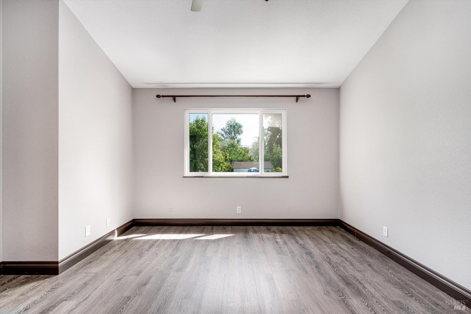 187 Wikiup Meadows Drive Santa Rosa, CA 95403 - Photo 38 of 66 an empty room with wooden floor and windows