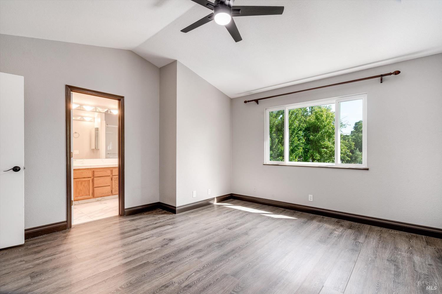 187 Wikiup Meadows Drive Santa Rosa, CA 95403 - Photo 39 of 66 a view of an empty room with wooden floor and a window