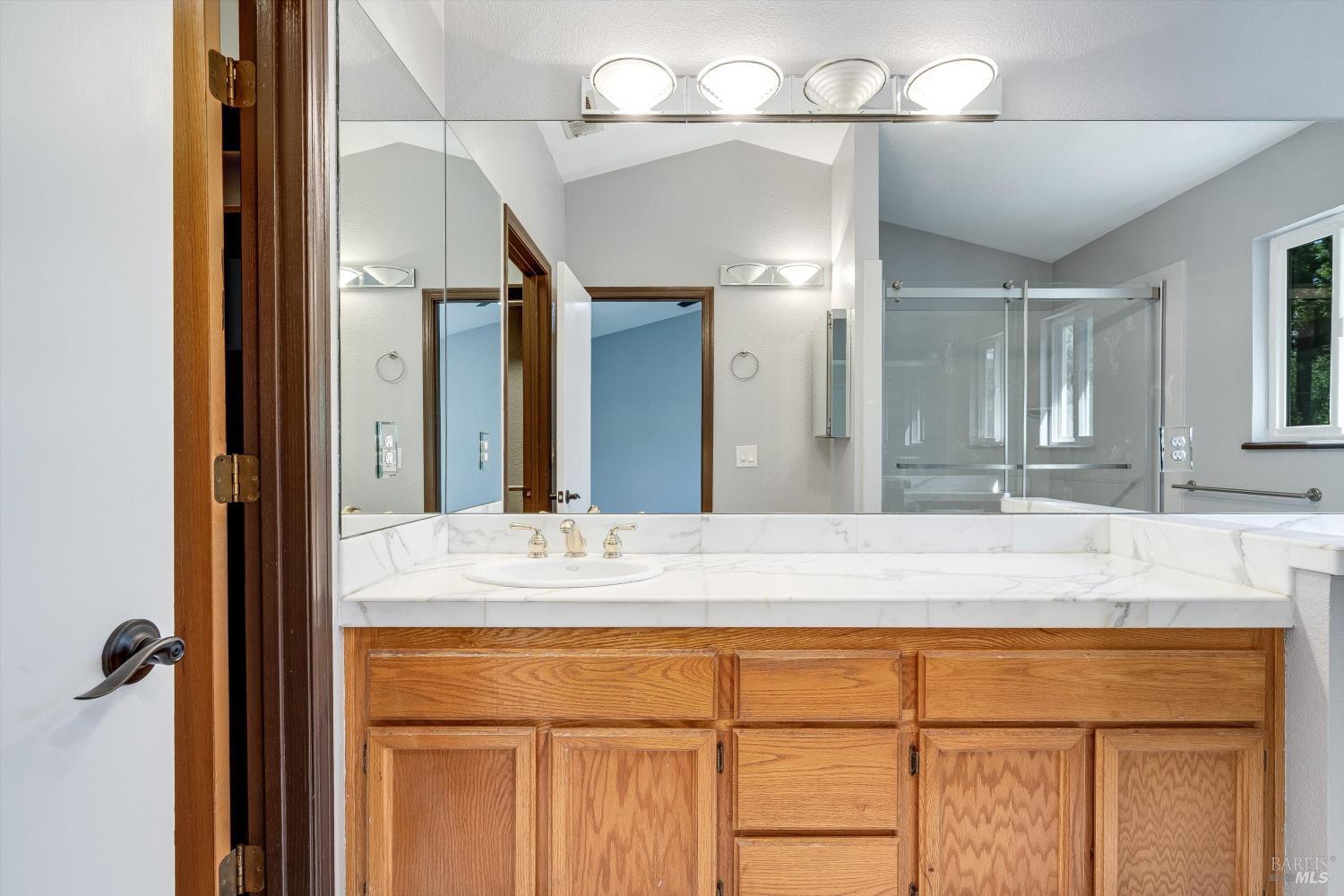 187 Wikiup Meadows Drive Santa Rosa, CA 95403 - Photo 41 of 66 a bathroom with a sink vanity and a mirror