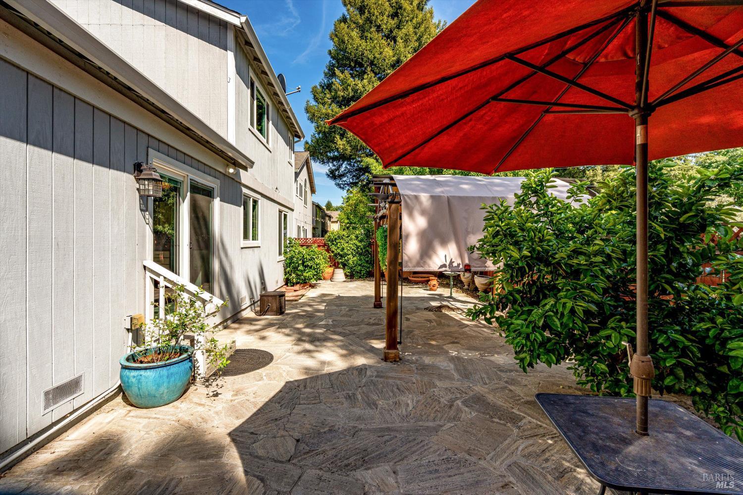 187 Wikiup Meadows Drive Santa Rosa, CA 95403 - Photo 49 of 66 a view of a backyard with table and chairs under an umbrella