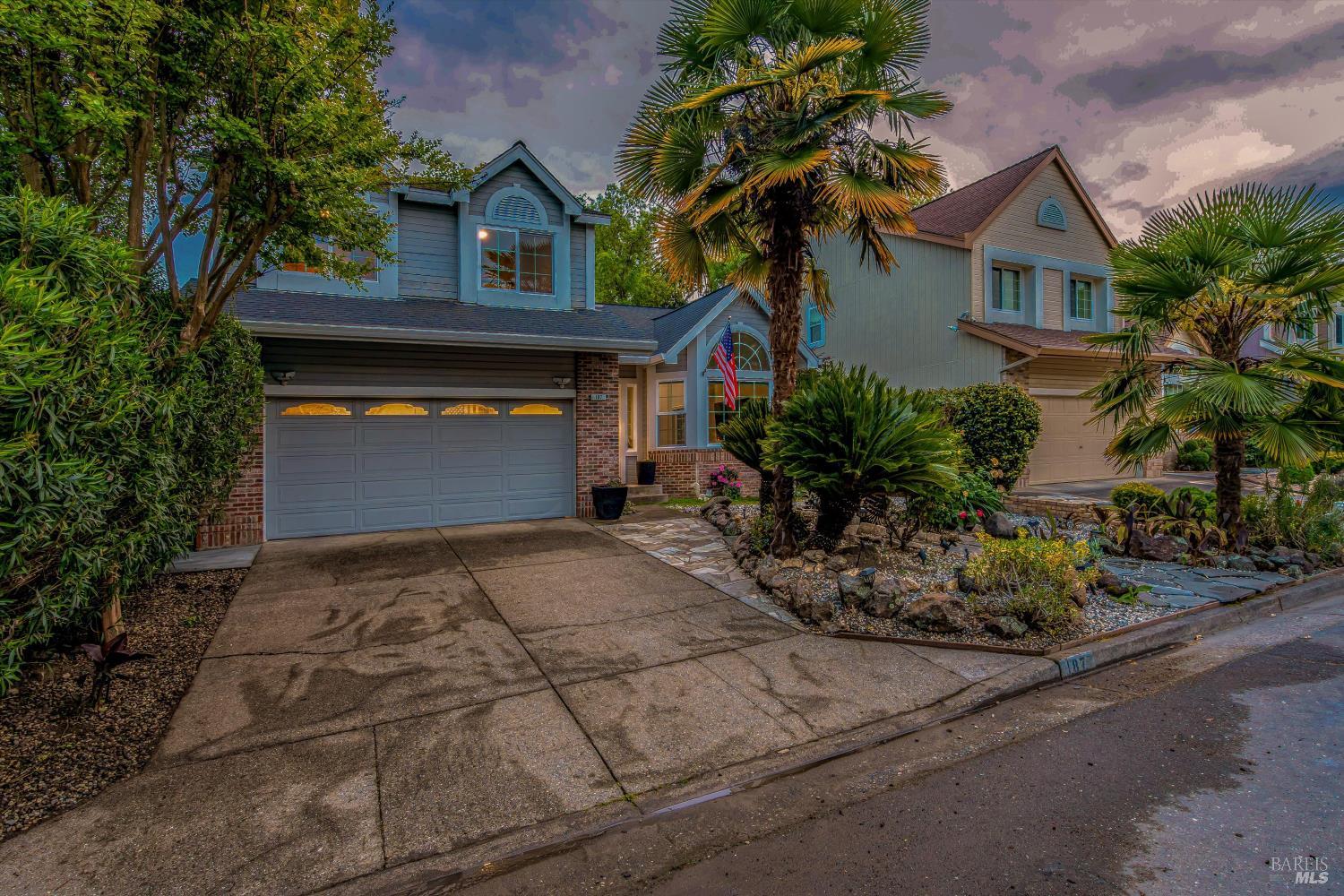 187 Wikiup Meadows Drive Santa Rosa, CA 95403 - Photo 65 of 66 a front view of a house with a yard and garage