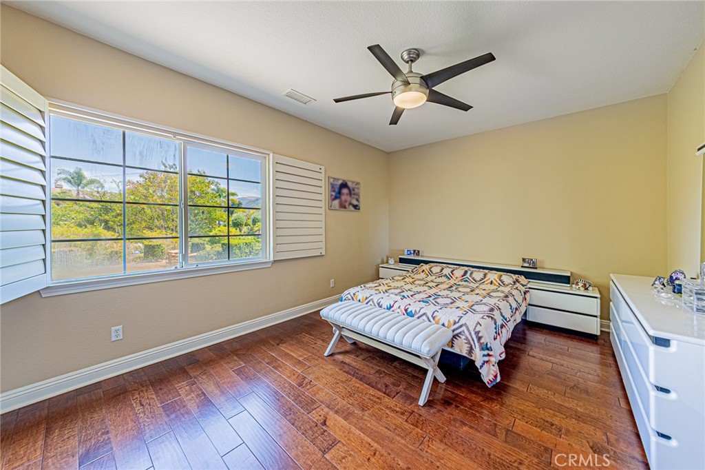 4088 Shady Ridge Circle Corona, CA 92881 - Photo 26 of 47 a living room with a bed furniture and a window