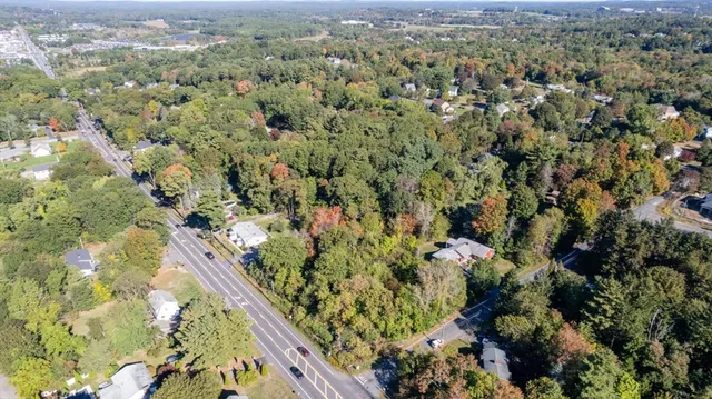 an aerial view of a house with a yard and garden