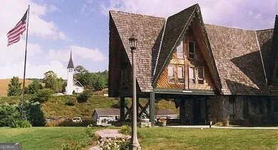 a view of a patio with table and chairs next to a yard