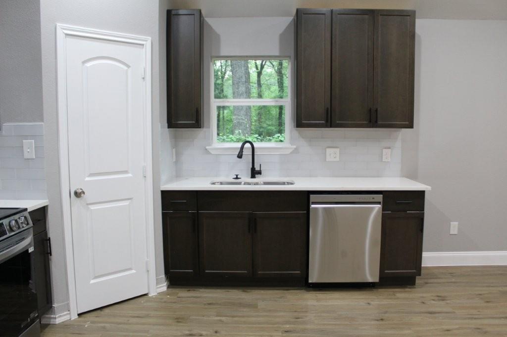 125 Chapperall Drive Mabank, TX 75156 - Photo 8 of 11 a kitchen with a sink and a mirror