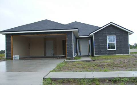 96070 Graylon Drive Yulee, FL 32097 - Photo 1 of 1 a front view of a house with garden