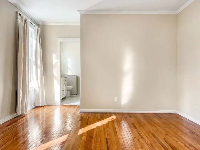 a view of an empty room and wooden floor