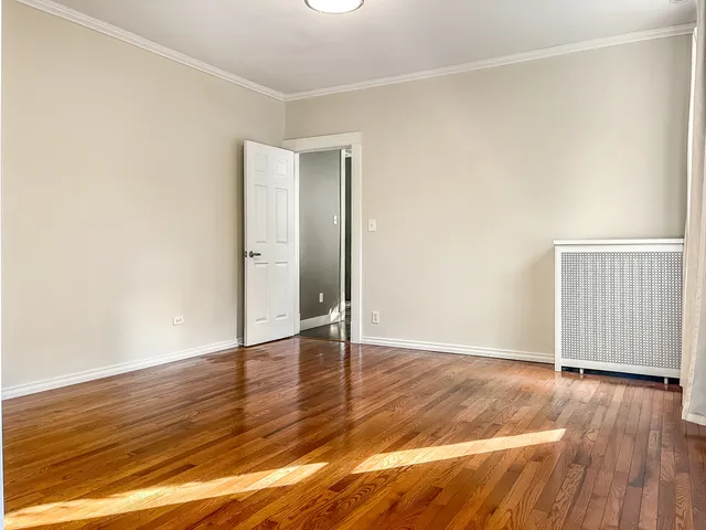 an empty room with wooden floor
