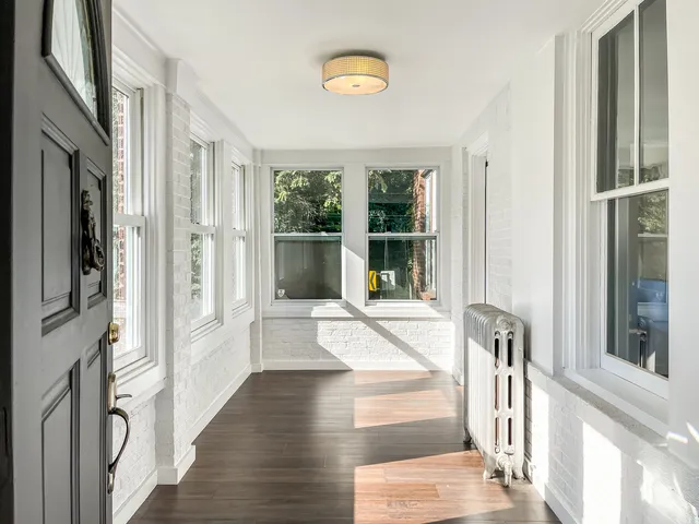 a view of an entryway with wooden floor and door