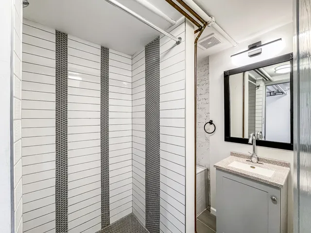a bathroom with a double vanity sink and a mirror