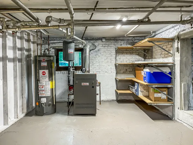 a utility room with dryer and racks