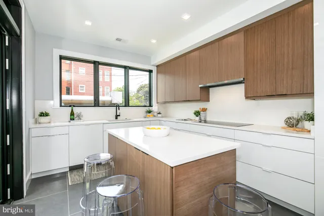a kitchen with a sink cabinets and window