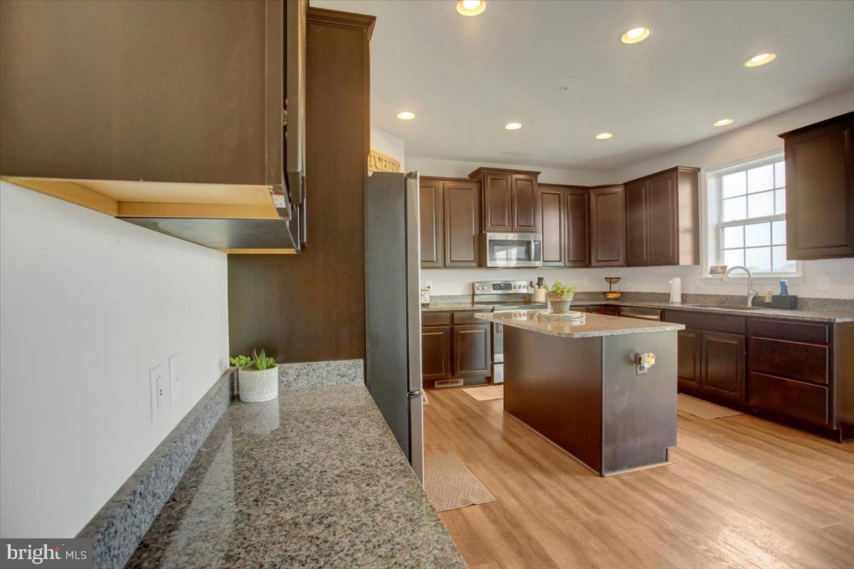 9822 Ripple Drive Williamsport, MD 21795 - Photo 13 of 41 a kitchen with stainless steel appliances granite countertop a stove a sink and a refrigerator