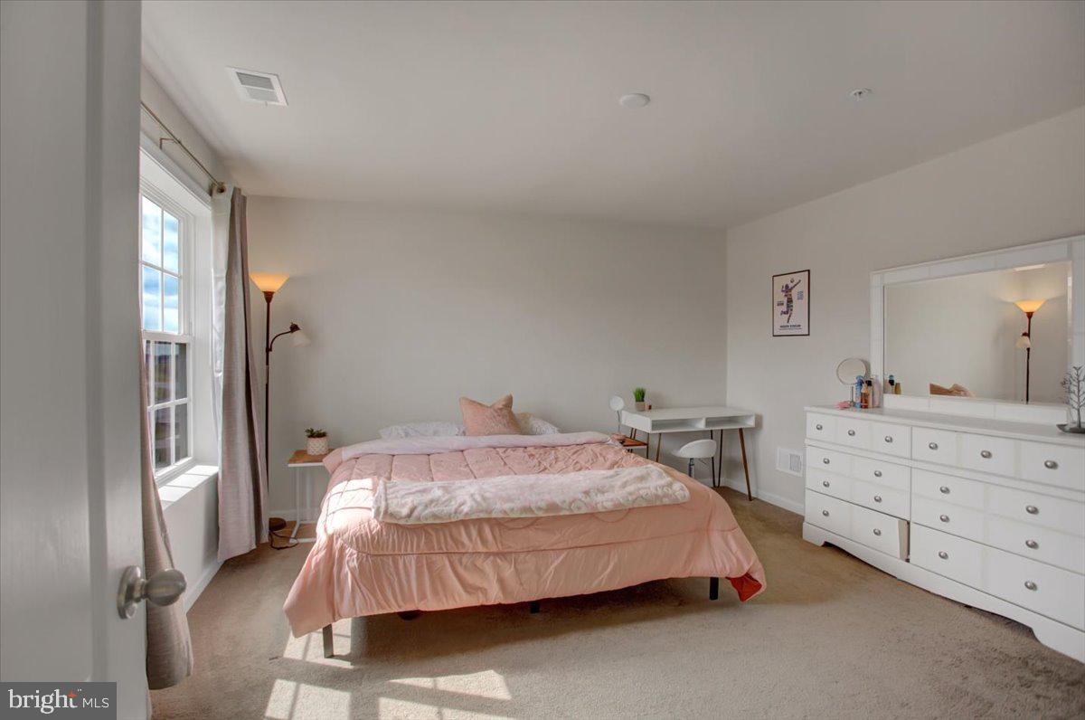 9822 Ripple Drive Williamsport, MD 21795 - Photo 22 of 41 a bedroom with a bed and dresser with mirror