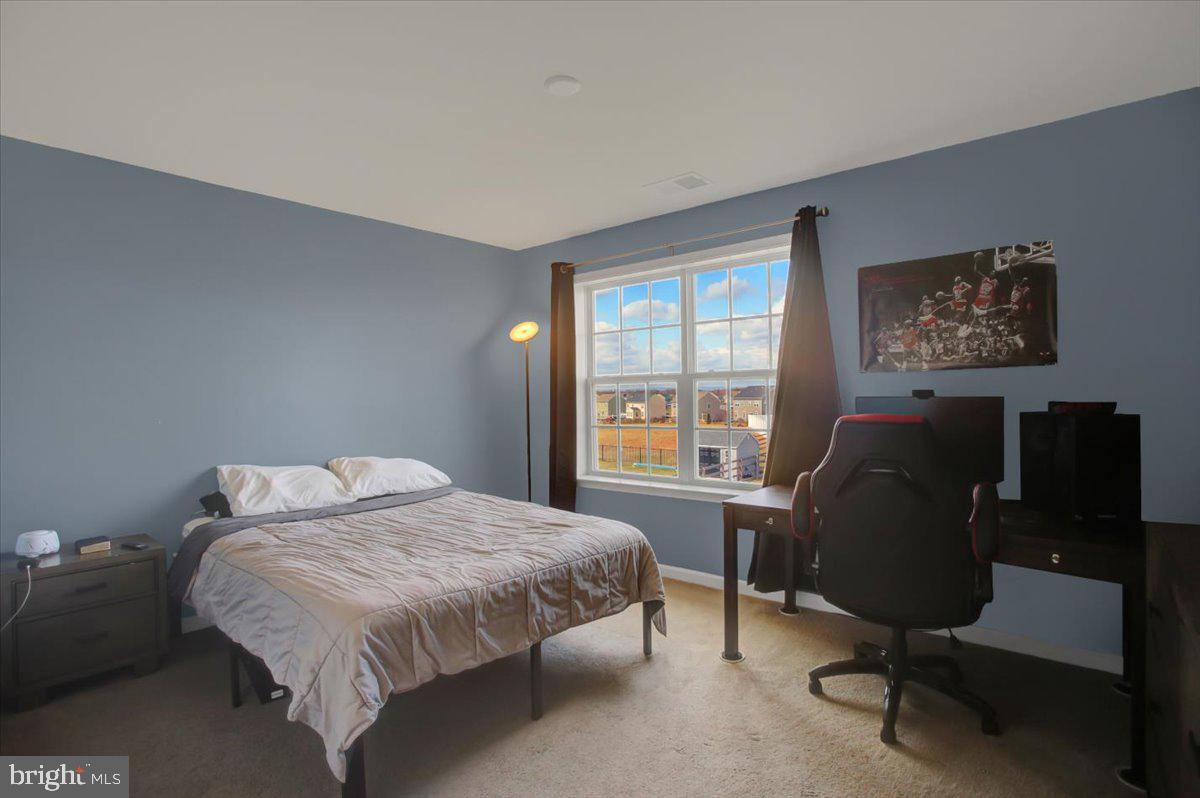 9822 Ripple Drive Williamsport, MD 21795 - Photo 31 of 41 a bed sitting in a bedroom next to a window