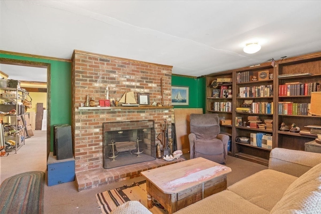 7 Brook Street Plympton, MA 02367 - Photo 24 of 42 a living room with furniture a fireplace and a book shelf