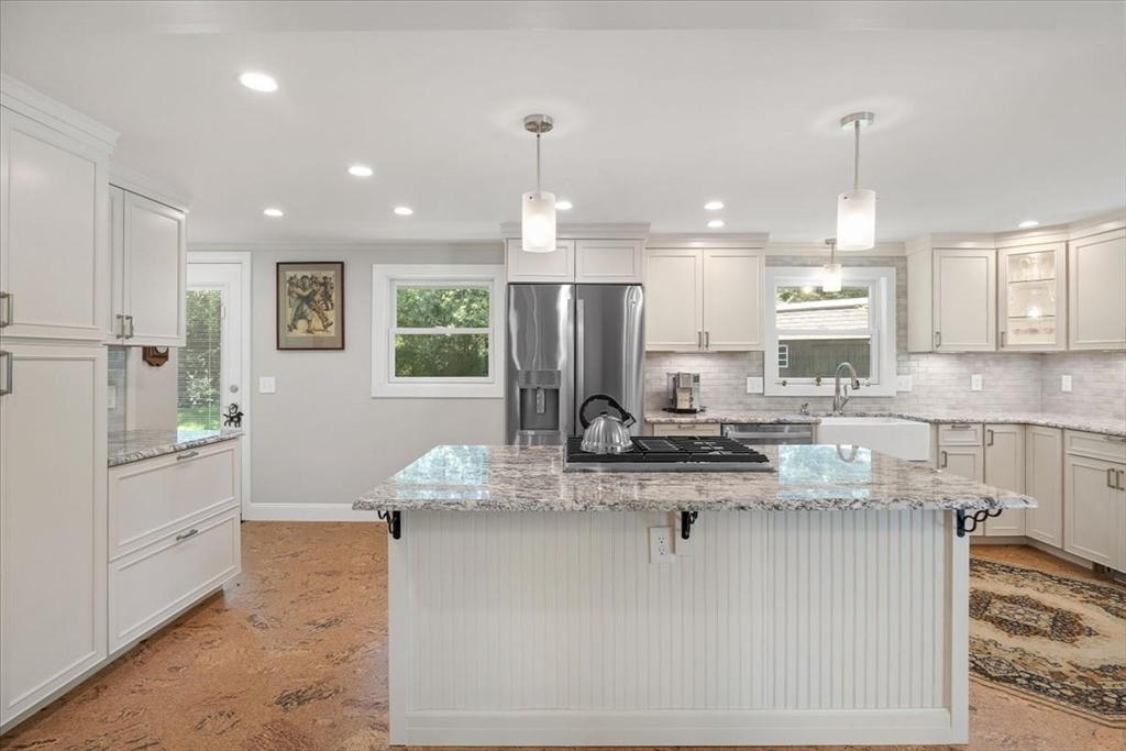 7 Brook Street Plympton, MA 02367 - Photo 10 of 42 a kitchen with kitchen island granite countertop a counter top space appliances and cabinets