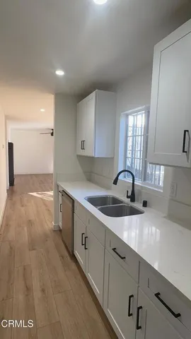 a kitchen with a sink and cabinets