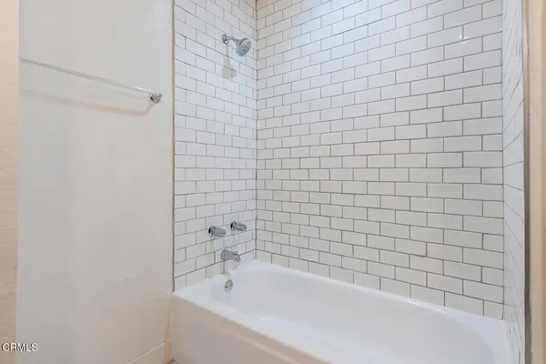 a bathroom with a bathtub and shower