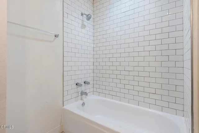 a bathroom with a bathtub and shower
