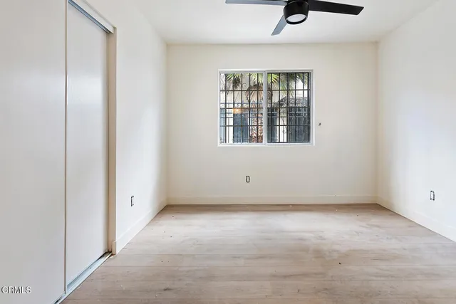 an empty room with windows and closet