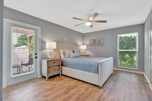 a dining room with furniture a chandelier and wooden floor