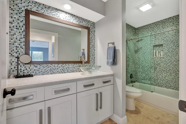 a living room with furniture a large window and a flat screen tv