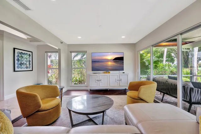 a view of a patio with table and chairs potted plants with wooden floor and fence