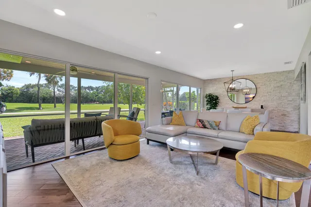 a view of a patio with a table chairs and backyard