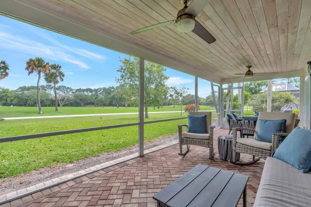 a view of a house with a yard and potted plants
