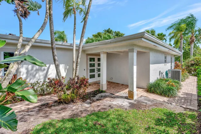 a view of house with outdoor space and swimming pool