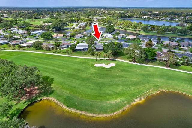 a patio with table and chairs and potted plants