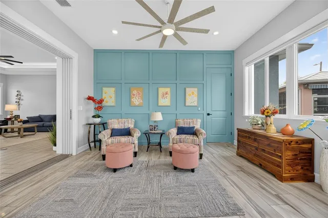 a bedroom with a bed and a flat tv screen on dresser