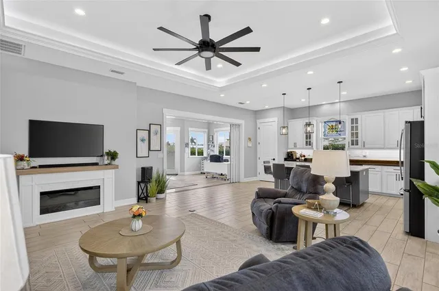 a living room with furniture a fireplace and a flat screen tv