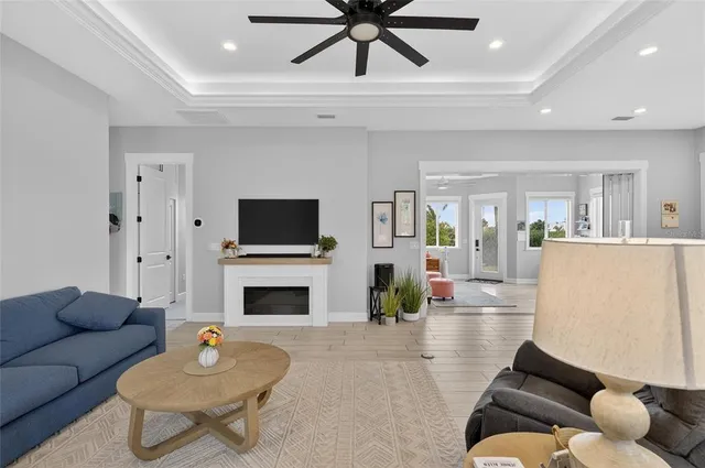 a living room with furniture a fireplace and a flat screen tv