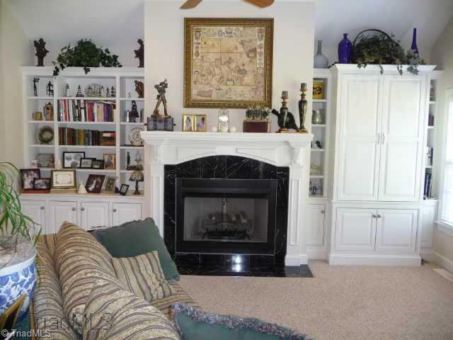 4460 Cotswold Road Pfafftown, NC 27040 - Photo 3 of 9 Other. Living room has built in shelving and cabinets, ceiling fan, cathedral ceiling, recessed lighting and French doors to brick patio.