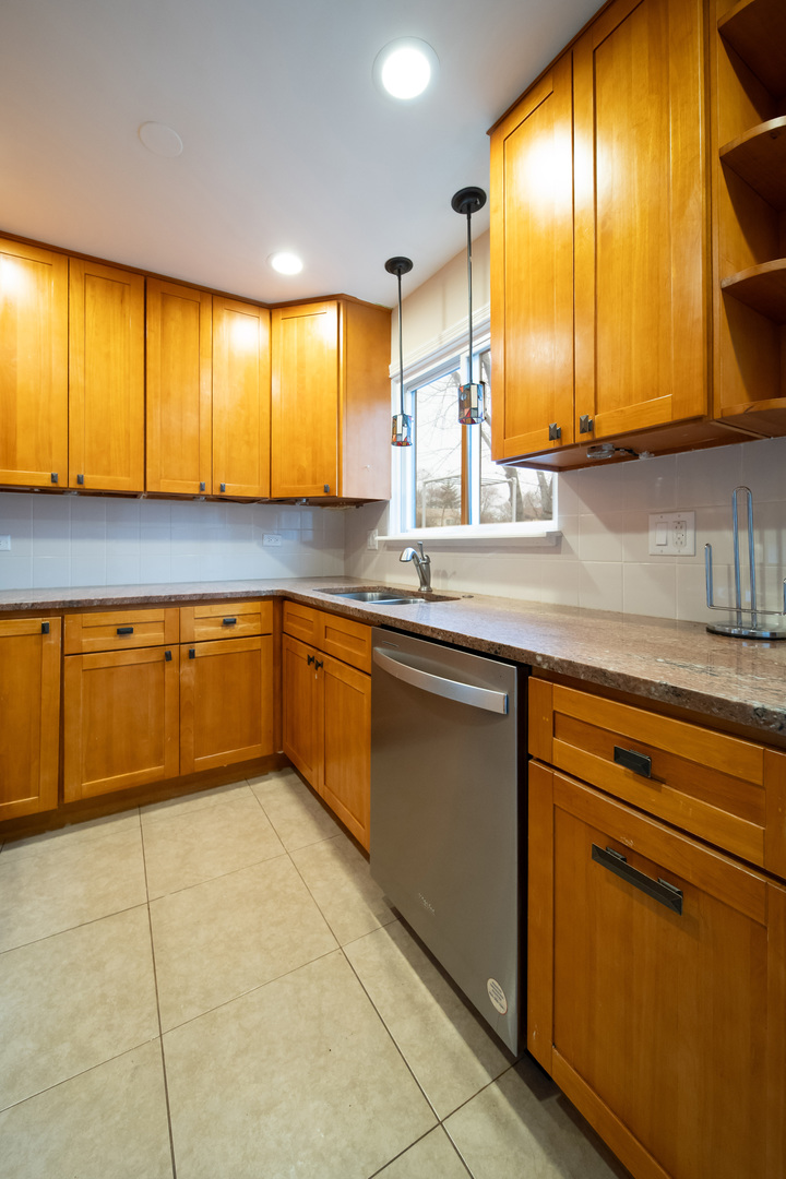 1504 Chippewa Trail Wheeling, IL 60090 - Photo 11 of 28 a kitchen with a sink cabinets and window
