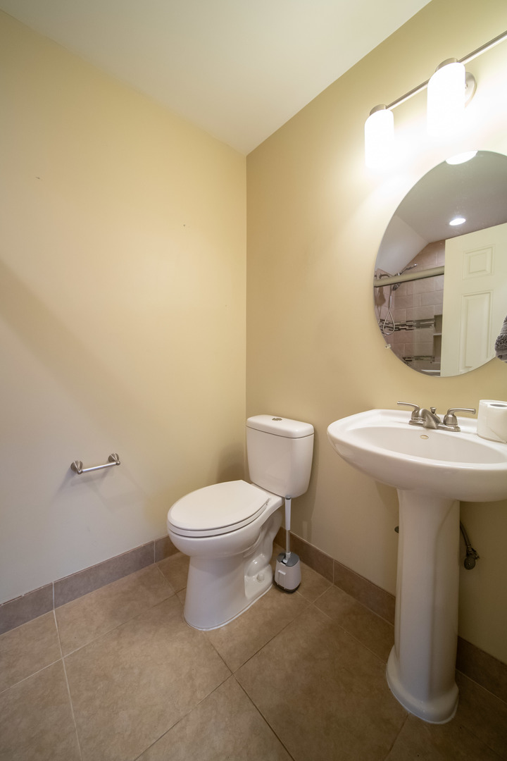 1504 Chippewa Trail Wheeling, IL 60090 - Photo 13 of 28 a bathroom with a sink mirror and toilet