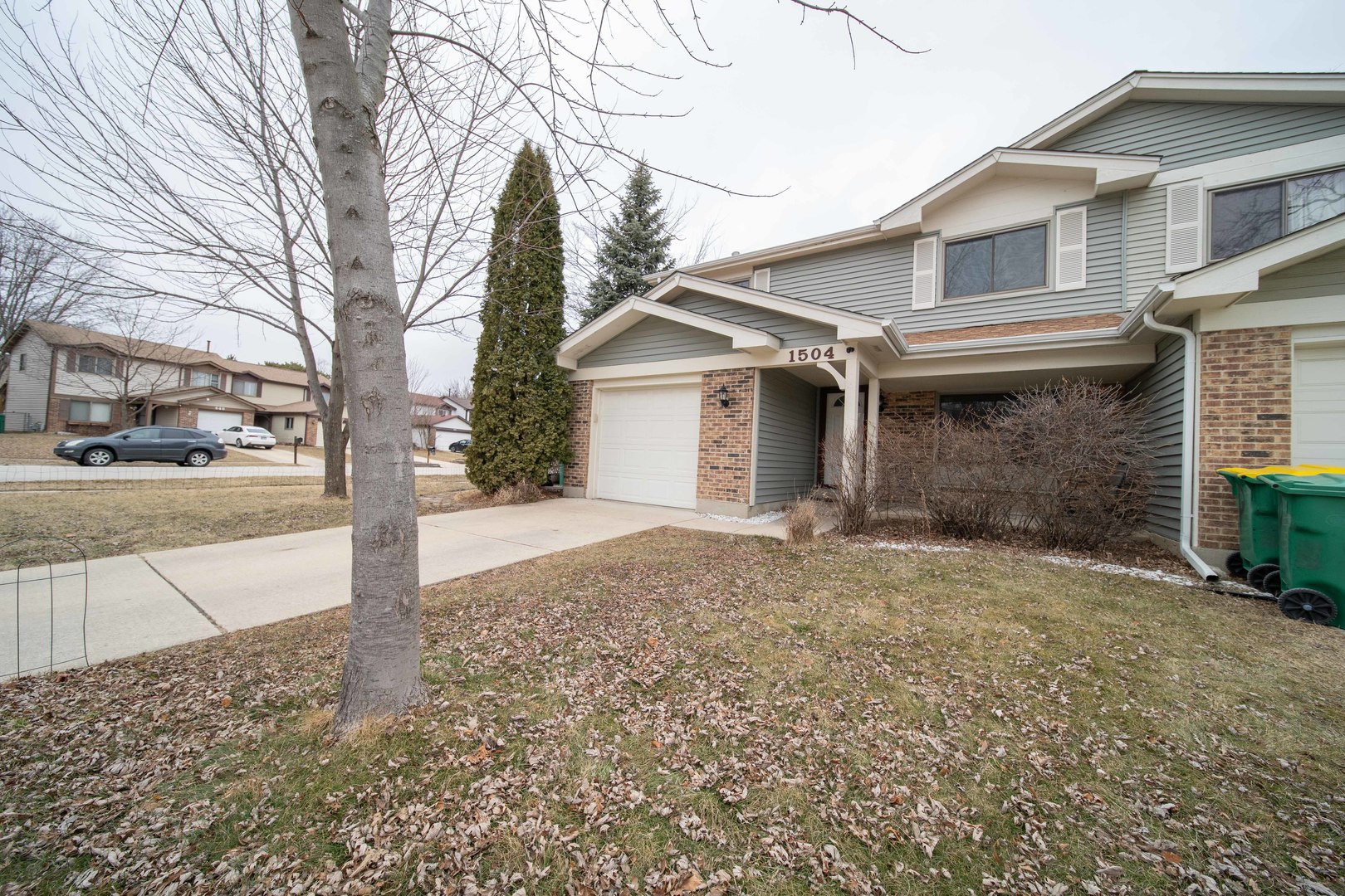 1504 Chippewa Trail Wheeling, IL 60090 - Photo 2 of 28 a view of a house with a yard covered in snow