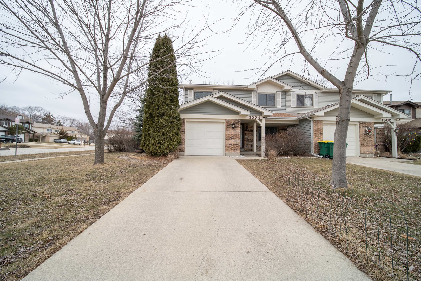1504 Chippewa Trail Wheeling, IL 60090 - Photo 3 of 28 a front view of a house with a yard and garage