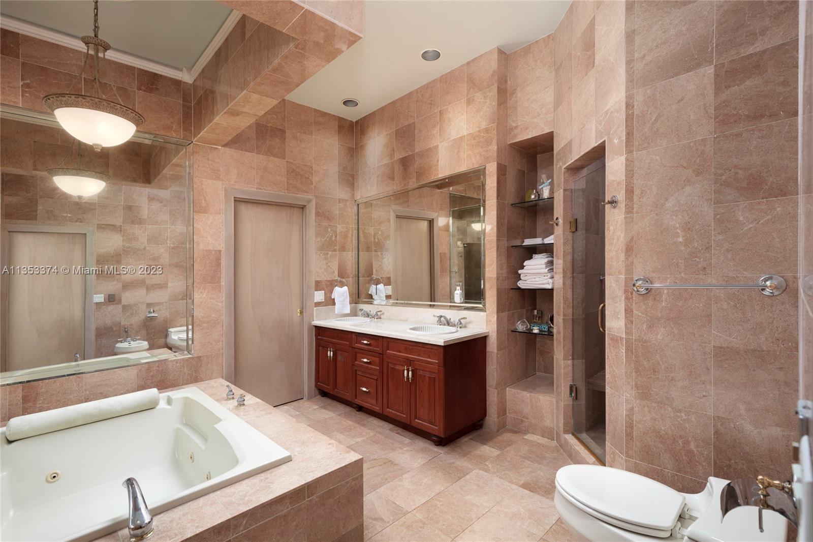 6745 Southwest 94th Street Pinecrest, FL 33156 - Photo 11 of 24 a bathroom with a sink vanity mirror and toilet