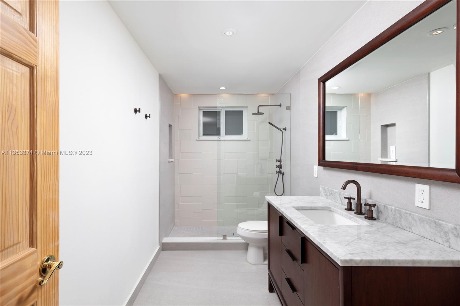 6745 Southwest 94th Street Pinecrest, FL 33156 - Photo 13 of 24 a bathroom with a sink and a mirror