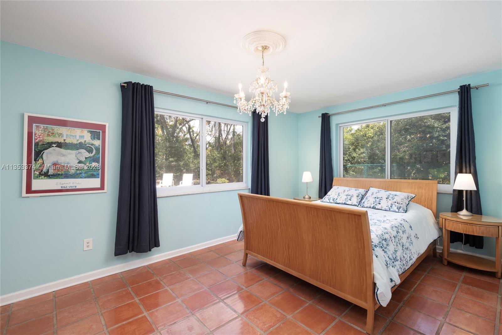 6745 Southwest 94th Street Pinecrest, FL 33156 - Photo 14 of 24 a bed room with a bed and a painting on the wall