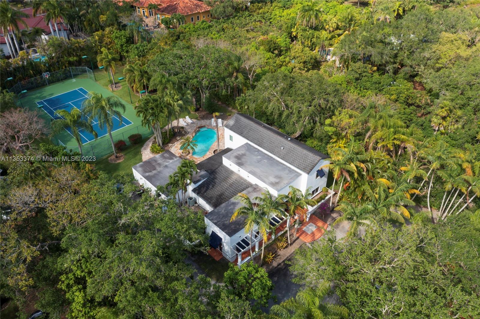 6745 Southwest 94th Street Pinecrest, FL 33156 - Photo 19 of 24 an aerial view of a house with a yard and garden