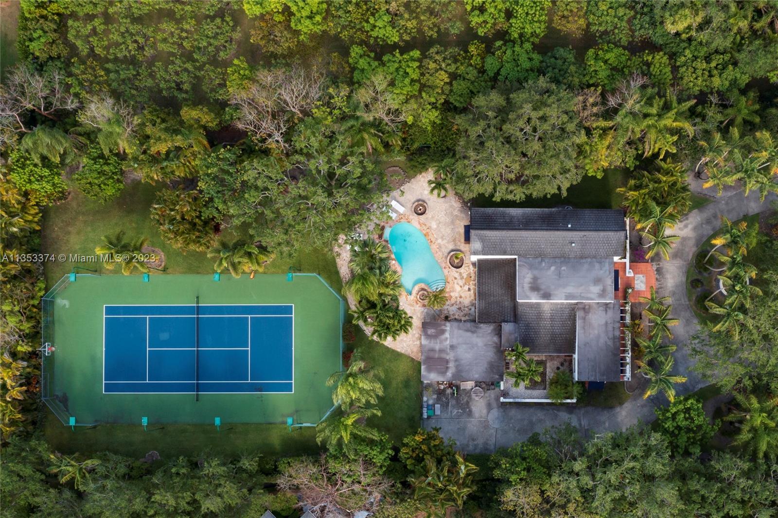 6745 Southwest 94th Street Pinecrest, FL 33156 - Photo 20 of 24 an aerial view of a house with yard and garage