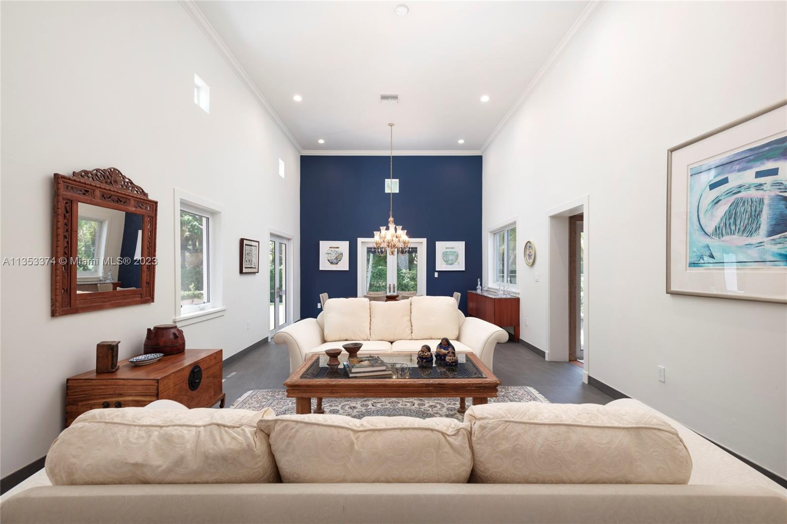 6745 Southwest 94th Street Pinecrest, FL 33156 - Photo 2 of 24 a living room with furniture and painting on the wall