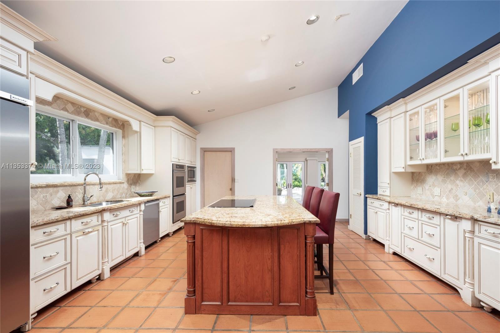 6745 Southwest 94th Street Pinecrest, FL 33156 - Photo 4 of 24 a kitchen with stainless steel appliances granite countertop a sink and cabinets