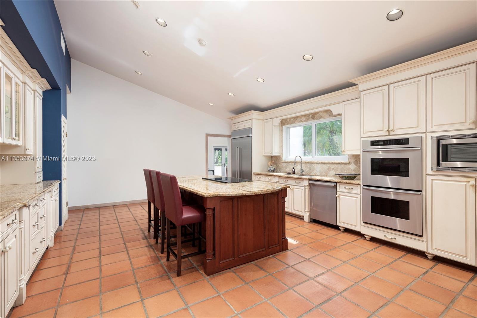 6745 Southwest 94th Street Pinecrest, FL 33156 - Photo 6 of 24 a kitchen with cabinets and chairs