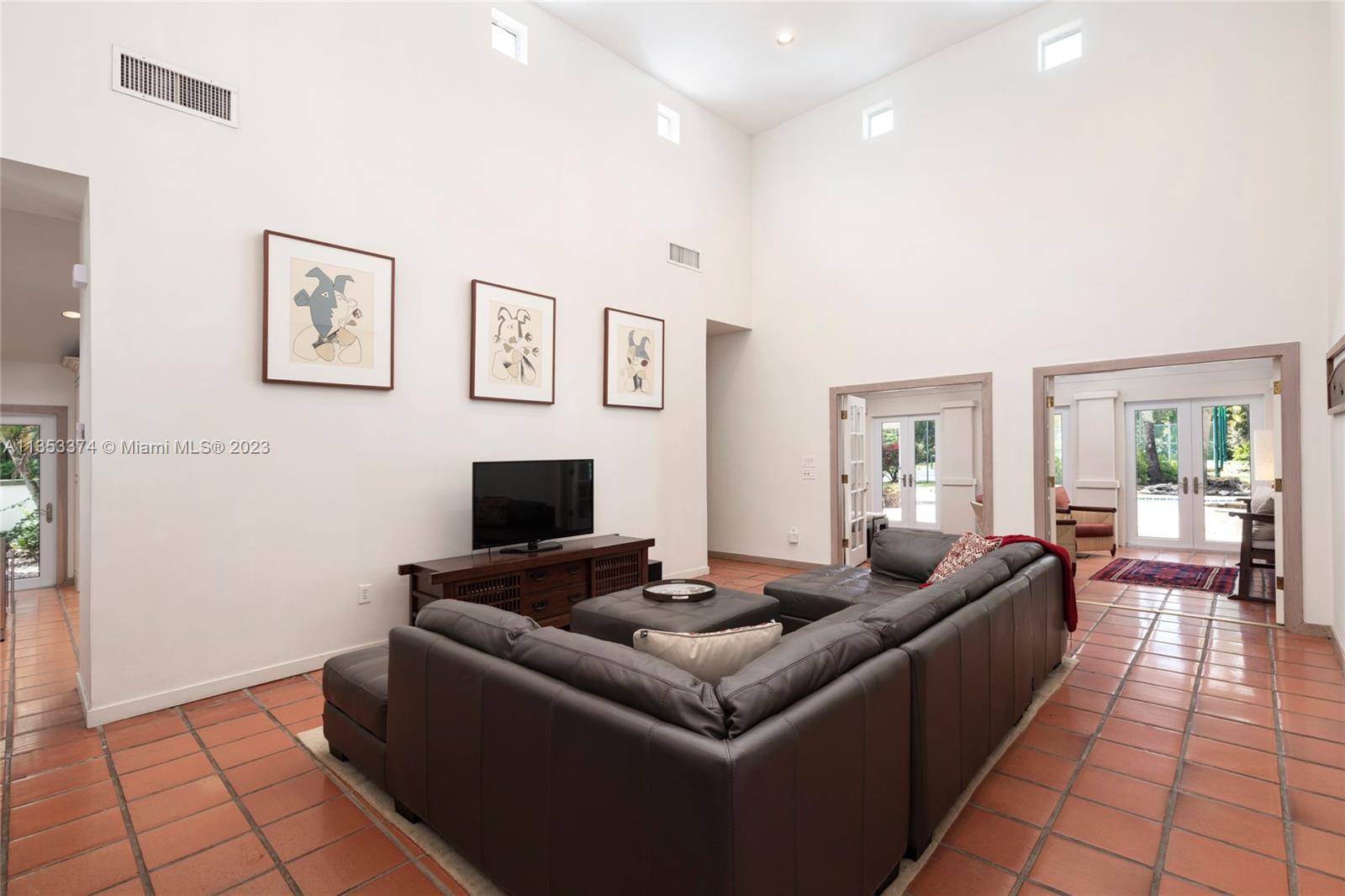 6745 Southwest 94th Street Pinecrest, FL 33156 - Photo 7 of 24 a living room with furniture and a flat screen tv